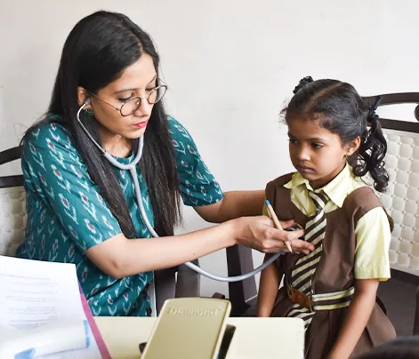 A doctor examining a child at a Shiksha Seva free health check-up camp