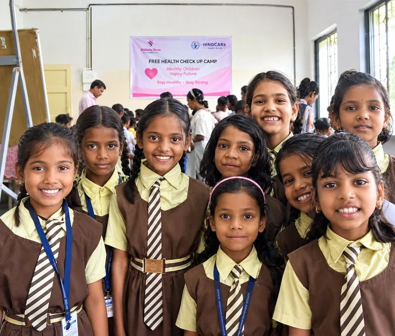 Schoolgirls in uniform seated together at a Shiksha Seva Foundation programme