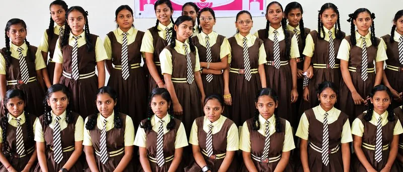 Group of schoolgirls in uniform smiling together at a Shiksha Seva Foundation programme