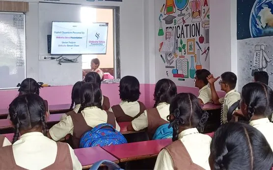 Students watching a digital lesson on a screen in a Shiksha Smart Class classroom